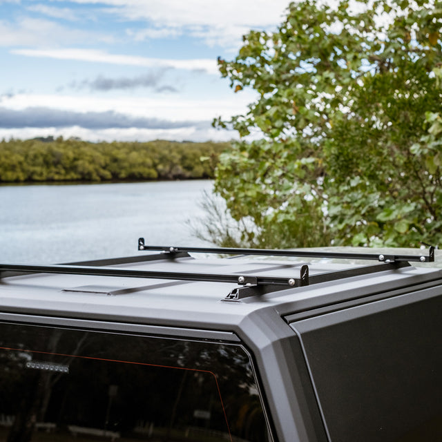 1200mm load bar set on a canopy roof by a lake