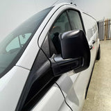 Car side mirror with black cover on a white car