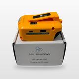 DeWalt-compatible USB & 12V Charger with LED Light: standing on its box