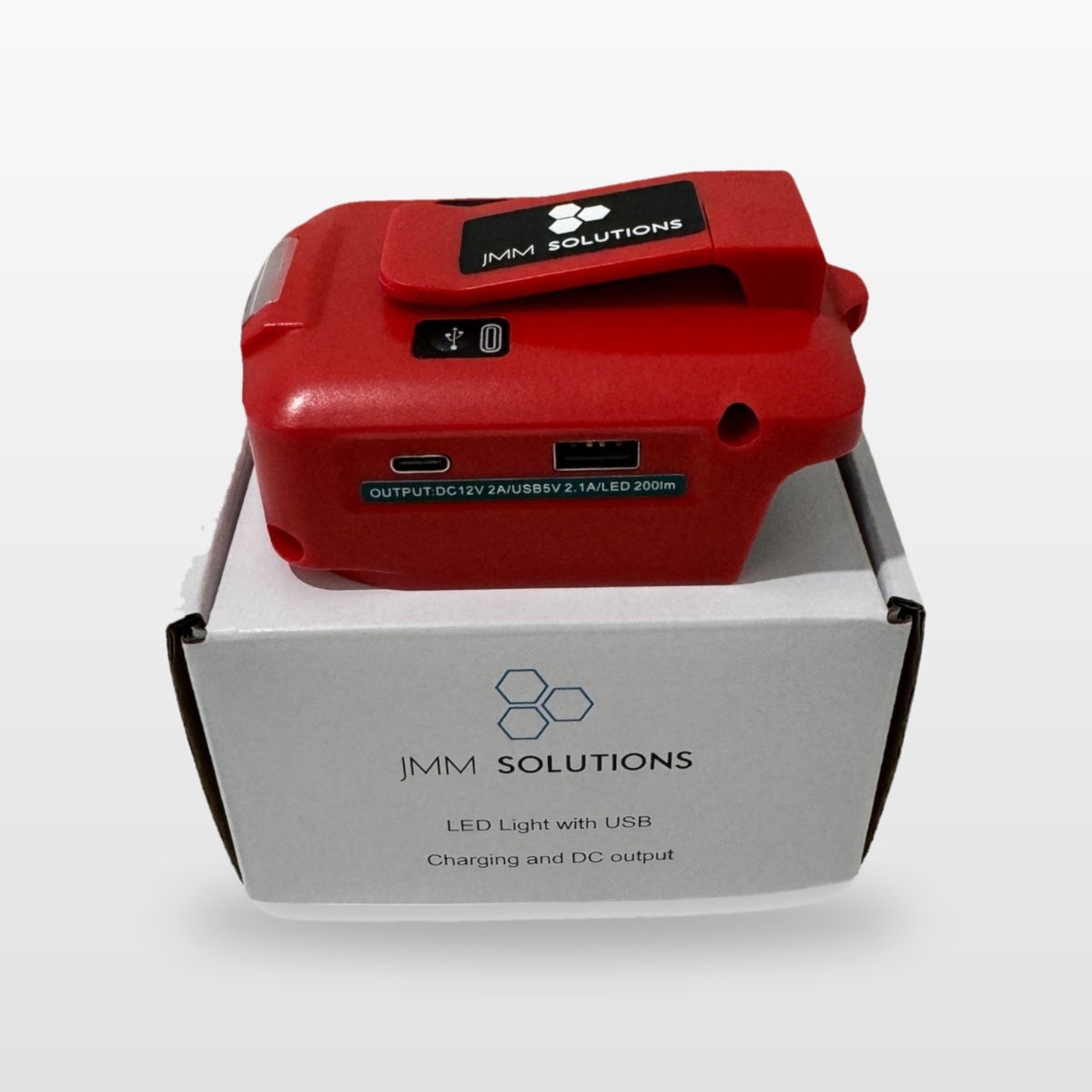 Milwaukee-compatible USB & 12V Charger with LED Light: standing on its box
