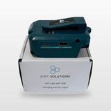 Makita-compatible USB & 12V Charger with LED Light: standing on its box