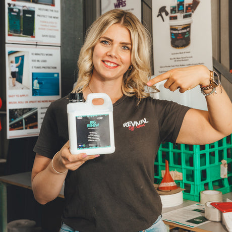Person holding a bottle of Revival product in a workshop setting